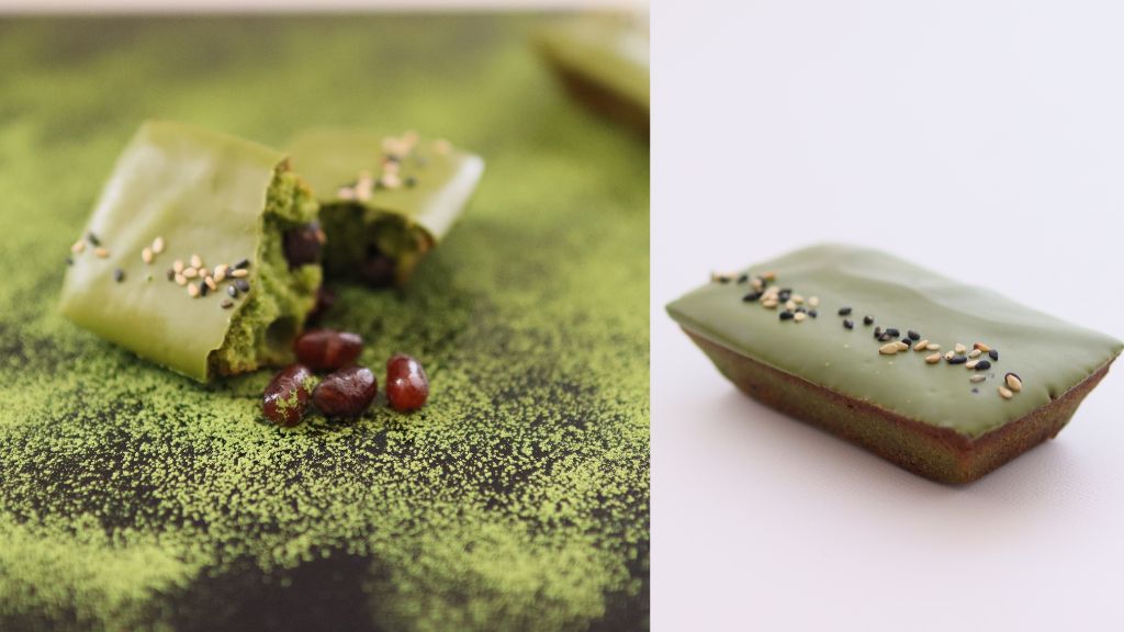 舞鶴産抹茶を使ったフィナンシェ。表面に黒白ごまがトッピングされ、断面には大納言が見える。抹茶パウダーが敷かれた背景の上に配置。